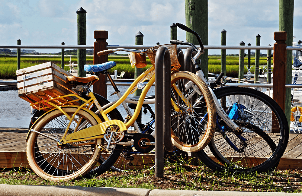 Improperly parked bicycles at a bike rack showing poor locking technique and inefficient use of space leading to security risks
